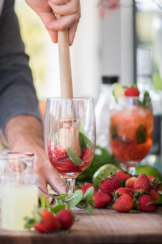 Muddle strawberries and mint for cocktail 