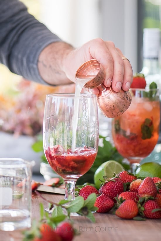 Adding lime juice to smashed strawberries