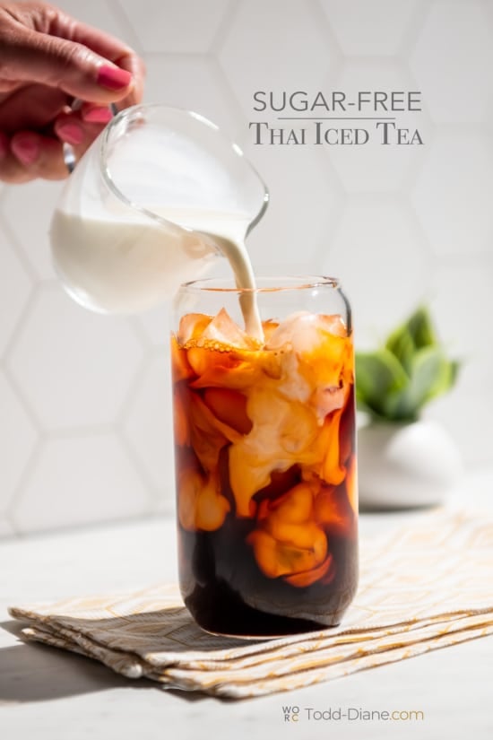 pouring cream into sugar free thai iced tea 