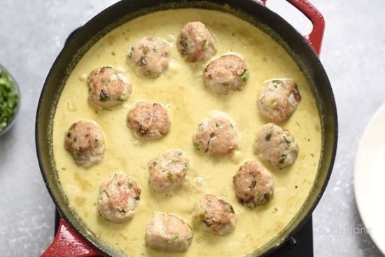 Meatballs in curry sauce in skillet