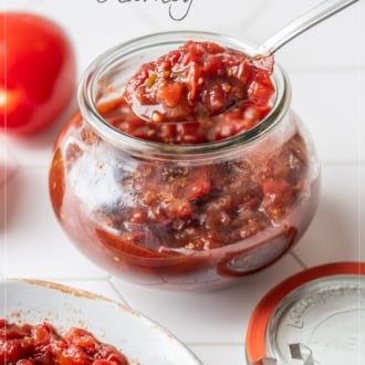 spooning tomato chutney in jar