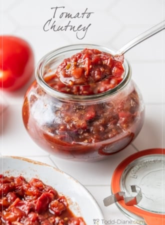spooning tomato chutney in jar
