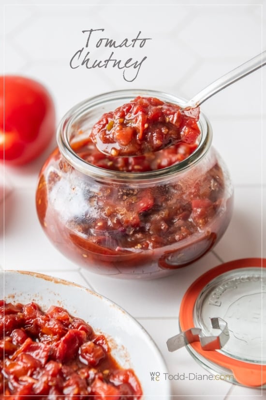 spooning tomato chutney in jar