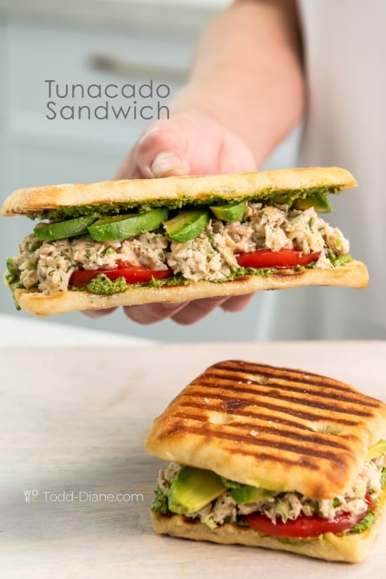 holding tunacado sandwich 