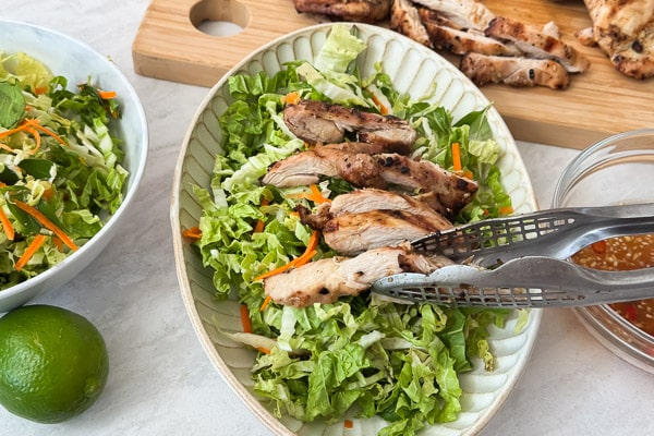 Adding chicken to the salad