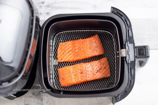 Salt and peppered uncooked salmon in air fryer