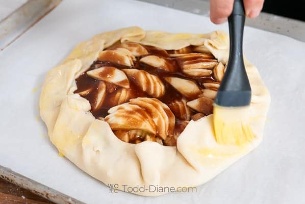 brushing egg over dough edges