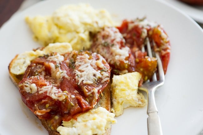 Baked Tomatoes on toast on a plate close up