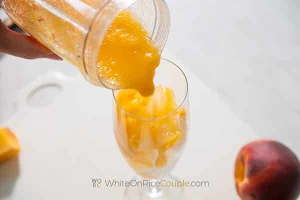 Pouring peach mix over ice