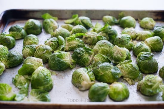 Uncooked brussels sprouts on sheet pan