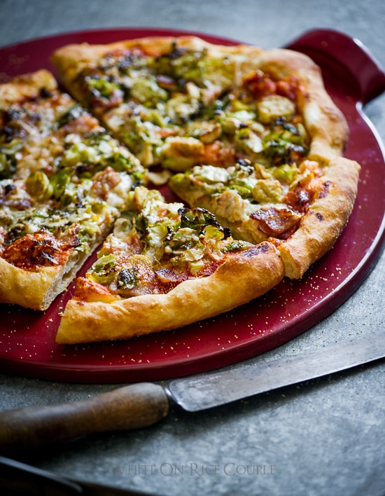 Brussels Sprouts and Bacon Pizza on a cutting board close up
