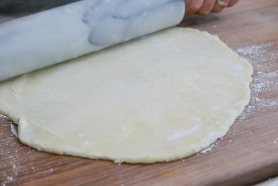 rolling out fresh pie dough