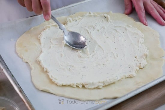 spreading softened cheese over pie dough