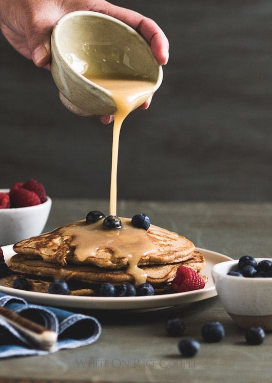 Chai Zucchini Pancakes with Buttermilk Syrup pouring over pancakes