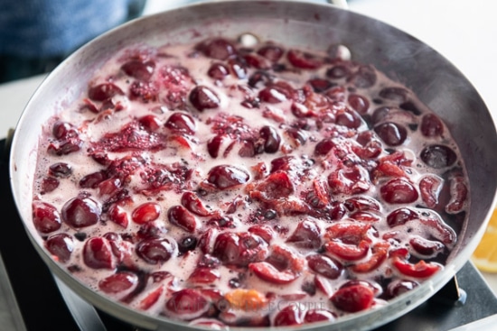 Cherry filling bubbling in a saucepan