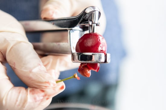 Pitting a cherry using a cherry pitter