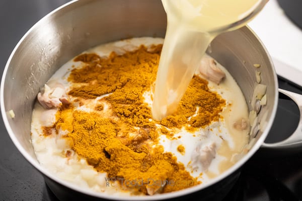 adding spices to soup