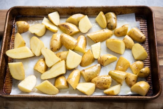 Raw cut potatoes on baking sheet pan