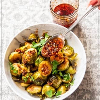 chili crisp brussels sprouts with spoonful of chili crunch