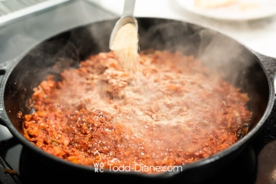 adding spices to pan