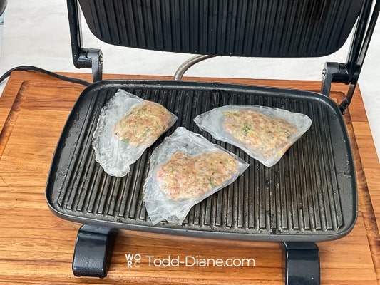 raw rice paper egg roll on panini press