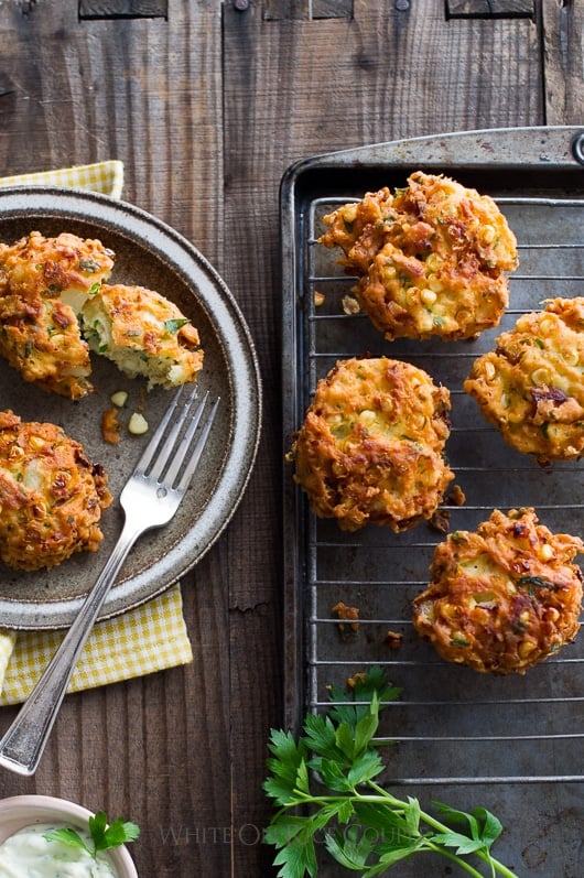 Sweet Corn Fritters on a cooling rack and plate with a fork