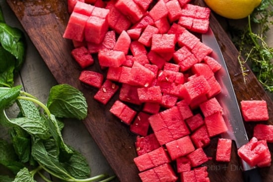 cubed watermelon on cutting board 