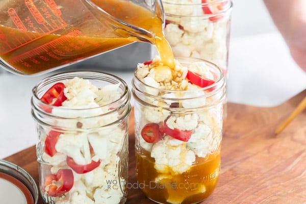 pouring brine into the jars