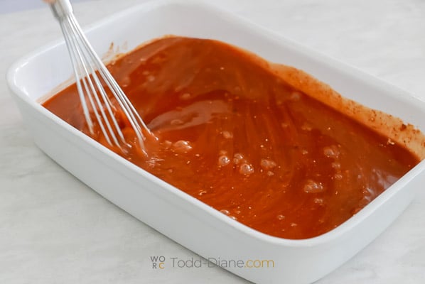 whisking sauce and seasonings