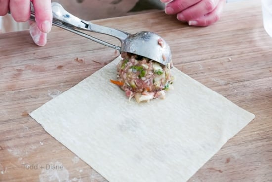 adding meat to egg roll wrapper