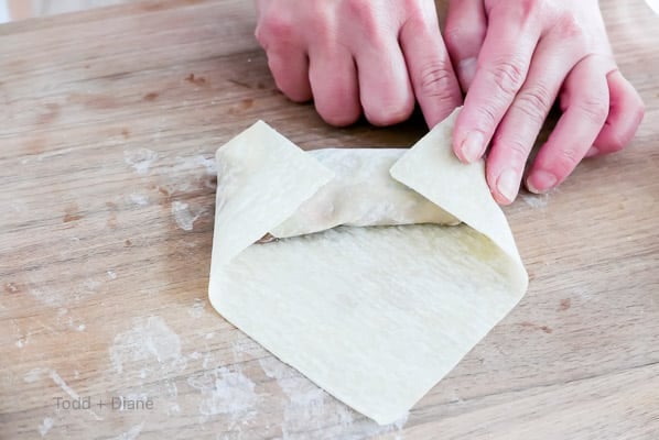 folding edges of egg rolls