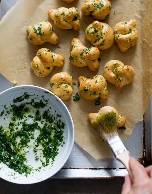 Easy Garlic Knot Recipe with Herb Butter on a baking sheet