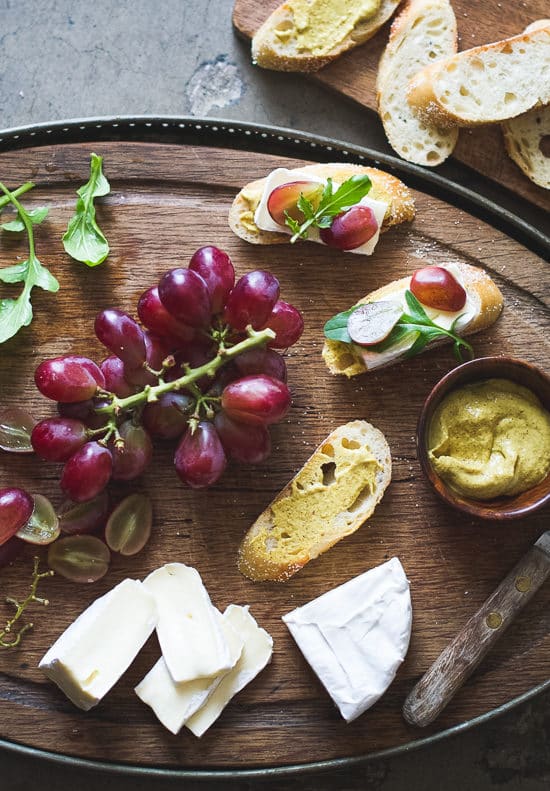 Easy appetizer recipe: Grape, Brie & Arugula Bruschetta on a cutting board