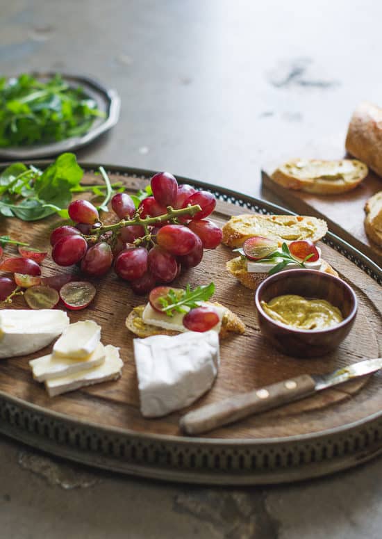 Easy appetizer recipe: Grape, Brie & Arugula Bruschetta on a cutting board