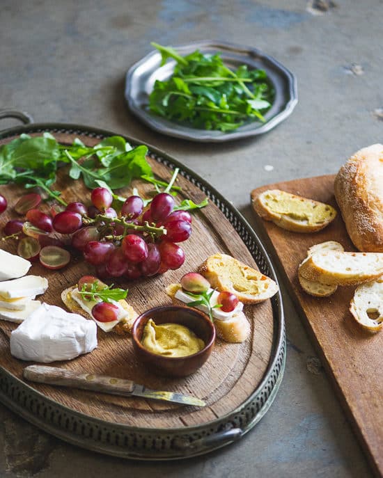 Easy appetizer recipe: Grape, Brie & Arugula Bruschetta on a cutting board