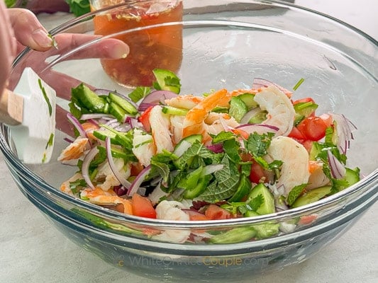 tossing salad together