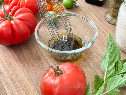 heirloom tomato salad dressing being made