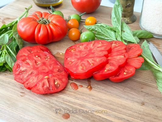 sliced heirloom tomatoes on cutting board