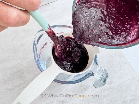 straining blackberry puree