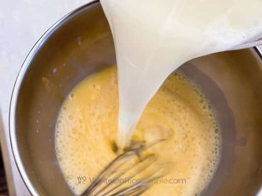 pouring milk into eggs