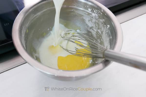 pouring hot milk into egg mixture