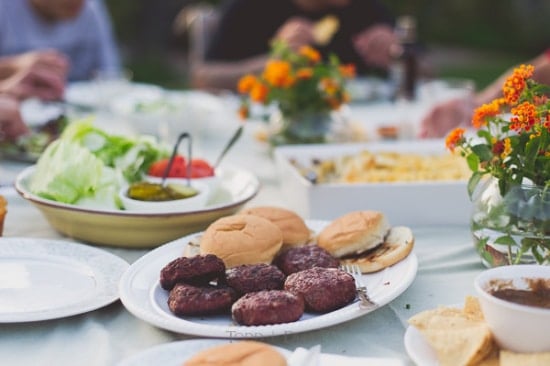Outdoor tablescape with burgers in the center