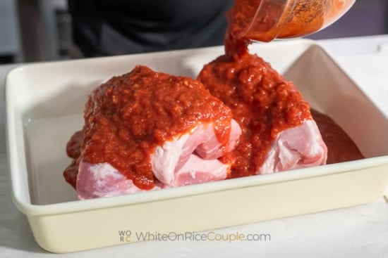 pouring marinade over pork