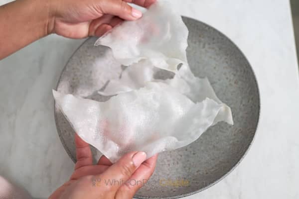 breaking rice paper cracker into bite sized pieces