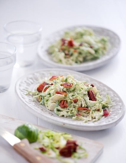 Shaved Brussels Sprouts Slaw with Bacon and Pecans on a serving plate