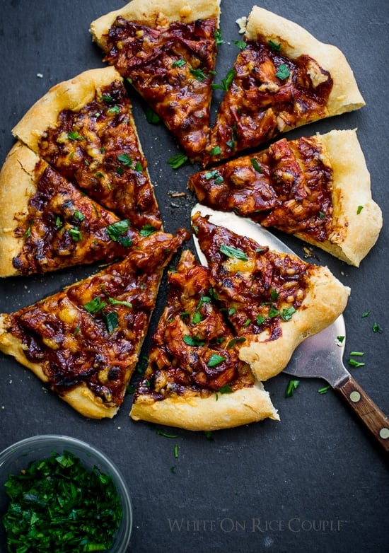 BBQ Turkey Pizza on a cutting board with a spatula