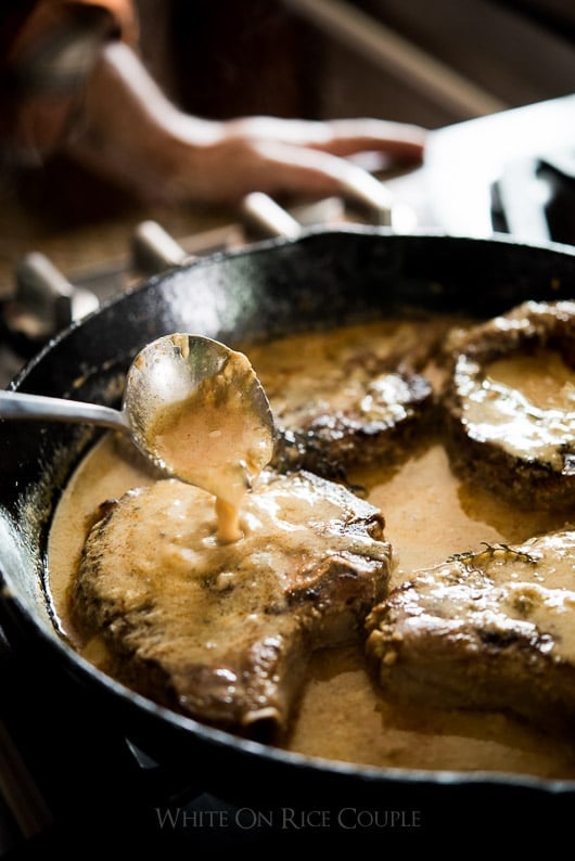 Juicy Tender Pork Chops recipe milk braised pork chops in a skillet