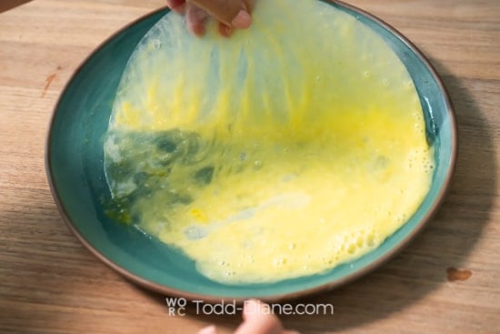 Dipping rice paper in egg