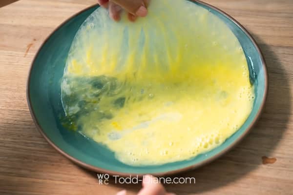 Dipping rice paper in egg