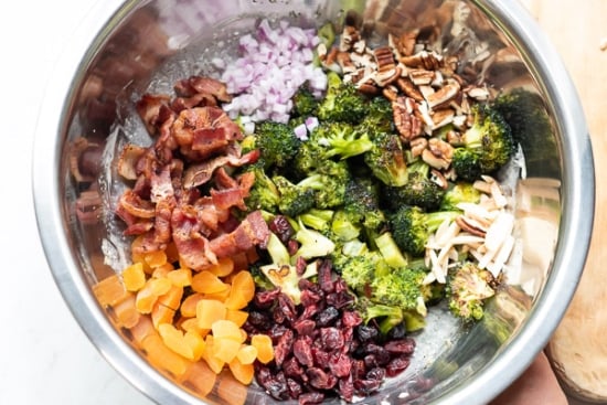 Roasted broccoli salad ingredients together in a bowl